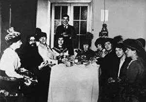 Alix Of Hesse Collection: Rasputin (second from left) at the meal among His Admirers, c. 1910