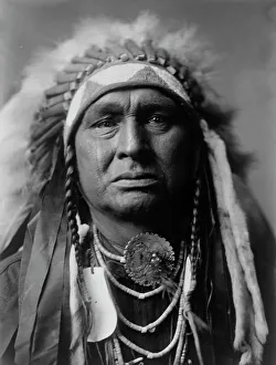 Traditional Tribal Clothing Prints: White Man Runs Him, Apsaroke, c1908. Creator: Edward Sheriff Curtis