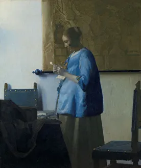 Prints of Woman Reading a Letter, c.1663. Other Title(s): Woman in Blue Reading a Letter. In a quiet, private moment, a young woman stands, engrossed in reading a letter Netherlands Prints: Jan Vermeer's Woman Reading a Letter, c.1663 Print