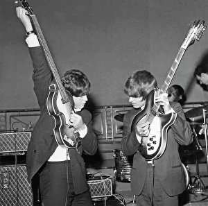 Paul McCartney and George Harrison tune their guitars Paul McCartney and George Harrison tune their guitars
