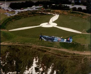 RAF Spitfire flies over the Battle of Britain Museum and Memorial at Capel-Le-Ferne in RAF Spitfire flies over the Battle of Britain Museum and Memorial at Capel-Le-Ferne in