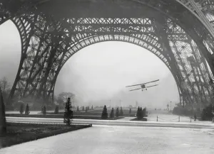 Prints of Lieut. Collot, flying through the base arch of the Eiffel Tower in Paris, France 1926 Eiffel Tower Prints: Flying under the Eiffel Tower Print, 1926