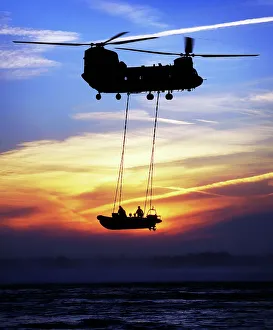 A Chinook helicopter and a Royal Marine rigid-inflatable boat (RIB), off Studland Bay, Dorset, UK A Chinook helicopter and a Royal Marine rigid-inflatable boat (RIB), off Studland Bay, Dorset, UK