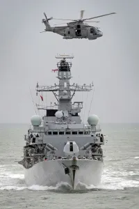 Royal Navy Type 23 Frigate HMS Sutherland with a Merlin Helicopter Overhead Royal Navy Type 23 Frigate HMS Sutherland with a Merlin Helicopter Overhead