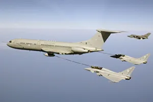 Two Typhoon fighters refuel in mid air with a VC 10 aircraft Two Typhoon fighters refuel in mid air with a VC 10 aircraft