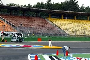 Images Dated 25th July 2002: Formula One World Championship: The finishing touches are made to the severely tightened first