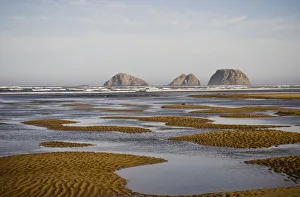Three Arch Rocks Are Viewed From The Mouth Of Netarts Bay; Netarts, Oregon, United States Of America Three Arch Rocks Are Viewed From The Mouth Of Netarts Bay; Netarts, Oregon, United States Of America