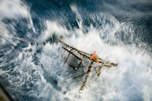 A Baited Pot Crashes Into The Water From Aboard The F/V Centurion In Kachemak Bay, Alaska A Baited Pot Crashes Into The Water From Aboard The F/V Centurion In Kachemak Bay, Alaska