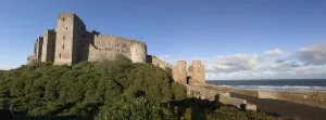 Bamburgh Castle Ruins Against A Blue Sky; Bamburgh Northumberland England Bamburgh Castle Ruins Against A Blue Sky; Bamburgh Northumberland England