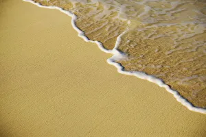 Close-Up Of Gentle Waves Washing Onto Sandy Tropical Beach Close-Up Of Gentle Waves Washing Onto Sandy Tropical Beach