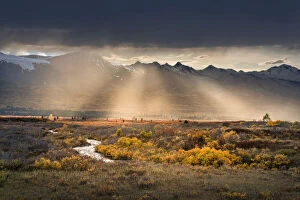 Alaska Highway Collection: Coast Mountain Range with rays of sunlight beaming across the autumn tundra, Alaska, USA