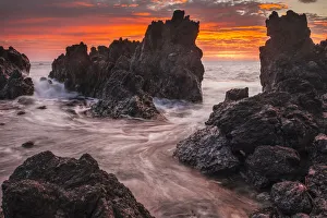 The Colours Of Sunrise Behind Coastal Lava Rocks; Laupahoehoe, Island Of Hawaii, Hawaii The Colours Of Sunrise Behind Coastal Lava Rocks; Laupahoehoe, Island Of Hawaii, Hawaii