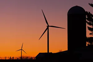 Elk Wind Energy Farm And A Silo At Sunrise, Near Edgewood; Iowa, United States Of America Elk Wind Energy Farm And A Silo At Sunrise, Near Edgewood; Iowa, United States Of America