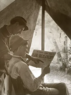 Two farmers looking at the Toronto Sunday News with headline 'War Declared', April 1917; Ontario, Canada Two farmers looking at the Toronto Sunday News with headline 'War Declared', April 1917; Ontario, Canada