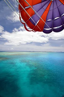 Fiji, Colorful parachute over reef and Pacific Ocean; Mamanuca Islands Fiji, Colorful parachute over reef and Pacific Ocean; Mamanuca Islands