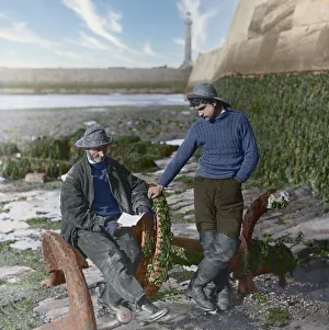 Fisherman and boy reading a letter near the pier in Whitby Fisherman and boy reading a letter near the pier in Whitby