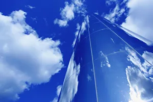 Glass Obelisk With Blue Sky And Cloud Reflections Glass Obelisk With Blue Sky And Cloud Reflections
