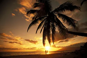 Hawaii, Maui, Kihei, Kamaole One, Distant View Of Couple Walking Along Beach At Sunset Hawaii, Maui, Kihei, Kamaole One, Distant View Of Couple Walking Along Beach At Sunset