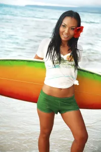 Hawaii, Oahu, Beautiful Local Girl Smiling And Holding A Colorful Surfboard At The Beach Hawaii, Oahu, Beautiful Local Girl Smiling And Holding A Colorful Surfboard At The Beach