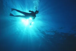 Hawaii, Oahu, Silhouette Of Scuba Diver Near The Surface Above Mahi Wreck Hawaii, Oahu, Silhouette Of Scuba Diver Near The Surface Above Mahi Wreck