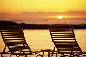 Hawaii, Two Silhouetted Chairs On Beach At Sunset, View From Behind Hawaii, Two Silhouetted Chairs On Beach At Sunset, View From Behind