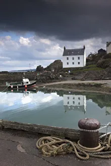 Houses Along The Water And A Boat On The Shore; St. Abb's Head, Scottish Borders, Scotland Houses Along The Water And A Boat On The Shore; St. Abb's Head, Scottish Borders, Scotland
