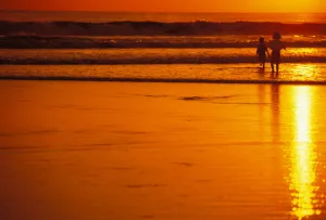 Indonesia, Bali, Kuta Beach At Sunset, Children Play In Shoreline, Orange Sky No Model Release Indonesia, Bali, Kuta Beach At Sunset, Children Play In Shoreline, Orange Sky No Model Release