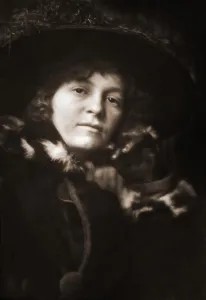 Low key portrait of a woman in a fur trimmed coat and large hat, Victorian or Edwardian era Low key portrait of a woman in a fur trimmed coat and large hat, Victorian or Edwardian era