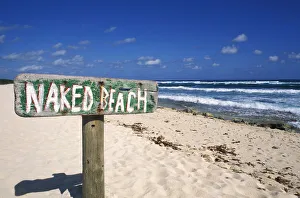 Mexico, Yucatan Peninsula, Cozumel, Naked Beach Sign In Sand, Ocean And Blue Sky In Background Mexico, Yucatan Peninsula, Cozumel, Naked Beach Sign In Sand, Ocean And Blue Sky In Background