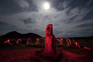 Ahu Tongariki Collection: A Moai is illuminated and surrounded by swirling hand held lights