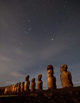 Ahu Tongariki Collection: Moai stand at night illuminated beneath a sky full of stars