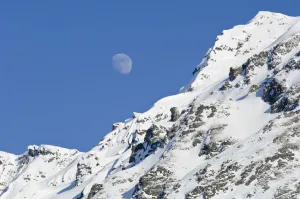 Moon Rising Over Snow Covered Mountain Peak At Hatcher Pass In Southcentral Alaska Moon Rising Over Snow Covered Mountain Peak At Hatcher Pass In Southcentral Alaska