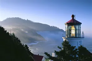 Oregon, View Of Heceta Head Lighthouse Early Morning Sun, Tree Covered Mountains Oregon, View Of Heceta Head Lighthouse Early Morning Sun, Tree Covered Mountains