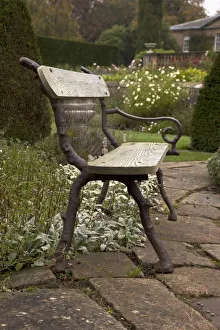 A Park Bench On A Stone Walkway; Northumberland, England A Park Bench On A Stone Walkway; Northumberland, England
