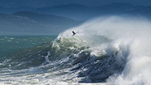 Images Dated 23rd February 2013: A Person Surfing In The Waves Along The Coast Of Cape Trafalgar; Cadiz, Andalusia, Spain