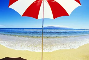 Red And White Umbrella On The Beach, Blue Sky And Ocean Red And White Umbrella On The Beach, Blue Sky And Ocean