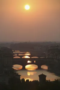 River Arno and famous bridge Ponte Vecchio, the oldest in Florence at sunset River Arno and famous bridge Ponte Vecchio, the oldest in Florence at sunset