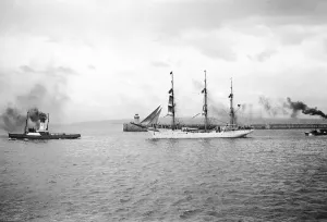 Sailing ship leaving the River Tyne towed by a tug and guided by pilot boat, 1950; Tyne and Wear, England Sailing ship leaving the River Tyne towed by a tug and guided by pilot boat, 1950; Tyne and Wear, England
