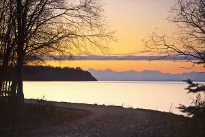 Scenic View Of Cook Inlet Along The Tony Knowles Coastal Trail At Sunset, Anchorage, Southcentral Alaska Scenic View Of Cook Inlet Along The Tony Knowles Coastal Trail At Sunset, Anchorage, Southcentral Alaska