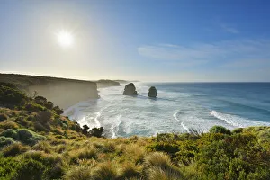 Scenic view of the limestone stacks of the Twelve Apostles backlit by the sun along the Great Ocean Road at Princeton Scenic view of the limestone stacks of the Twelve Apostles backlit by the sun along the Great Ocean Road at Princeton