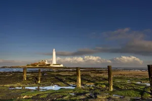 Shore And Lighthouse In Distance; Whitley Bay, Northumberland, England Shore And Lighthouse In Distance; Whitley Bay, Northumberland, England