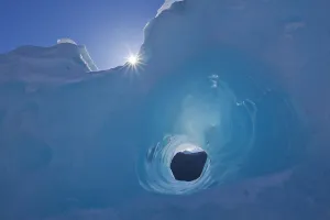 Small Tunnel Eroded In An Iceberg Frozen In Mendenhall Lake, Juneau, Southeast Alaska Small Tunnel Eroded In An Iceberg Frozen In Mendenhall Lake, Juneau, Southeast Alaska