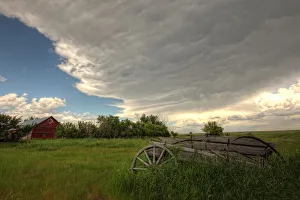 Storm Clouds Gather Over An Abandoned Farm Stead, Rural Saskatchewan Storm Clouds Gather Over An Abandoned Farm Stead, Rural Saskatchewan