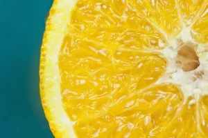 Studio shot of an orange half on a blue background Studio shot of an orange half on a blue background