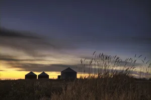 Sunset Silhouetting Grain Silos In Autumn, Rural Alberta Sunset Silhouetting Grain Silos In Autumn, Rural Alberta