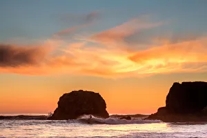 Surfing the cold water of Big Sur at sunset, California, USA Surfing the cold water of Big Sur at sunset, California, USA