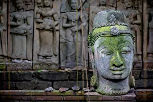A Terra Cotta Head Of Buddha Sits In Front Of Bas-Relief In A Terra Cotta Garden; Chiang Mai, Thailand A Terra Cotta Head Of Buddha Sits In Front Of Bas-Relief In A Terra Cotta Garden; Chiang Mai, Thailand
