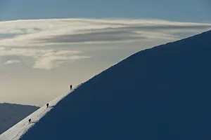 UK, Scotland, Walkers climbing snowy ridge of Sgorr Dhearg in winter near Glen Coe (Glencoe); Highlands UK, Scotland, Walkers climbing snowy ridge of Sgorr Dhearg in winter near Glen Coe (Glencoe); Highlands