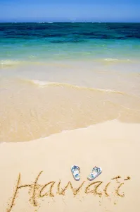 USA, Hawaii, Ocean in background; Kailua, Flipflops and Hawaii written in sand USA, Hawaii, Ocean in background; Kailua, Flipflops and Hawaii written in sand