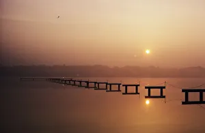 USA, New Jersey, Sunrise over inland waterway with reflections in smooth water; Cape May USA, New Jersey, Sunrise over inland waterway with reflections in smooth water; Cape May